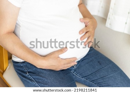 A 22nd week pregnant woman with a large belly due to uterine fibroids (Japanese, 30s)