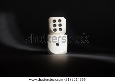 Two dices with number one and number six. Minimum and maximum. Cubes placed one on top of the other. Good luck in casino games. 