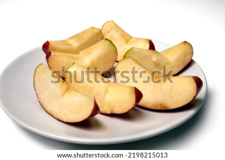 delicious apple slices on white plate and white background