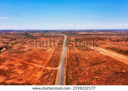 Silver city highway from Adelaide to Broken hill at entrance to Broken Hill city in australian red soil outback. Royalty-Free Stock Photo #2198222177