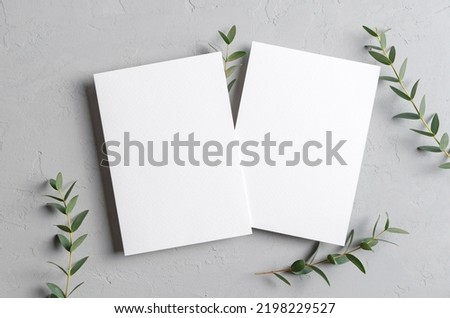 Wedding invitation card mockup with eucalyptus twigs, front and back sides