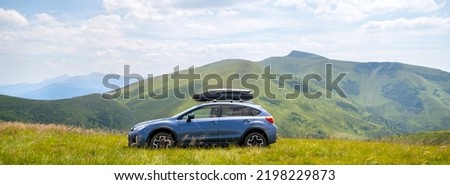 Blue off road car on mountain trail. Traveling by auto, adventure in wildlife, expedition or extreme travel on SUV automobile Royalty-Free Stock Photo #2198229873