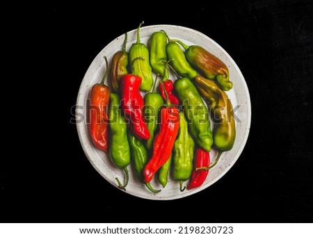 Pepperoncini peppers on a dark surface Royalty-Free Stock Photo #2198230723