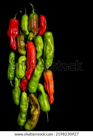 Pepperoncini peppers on a dark surface Royalty-Free Stock Photo #2198230927