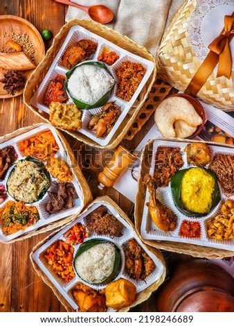 A food package consisting of several dishes such as fish, beef, chicken, eggs, rice, sambal, etc. This photo Can be used for promotional photos and advertisements