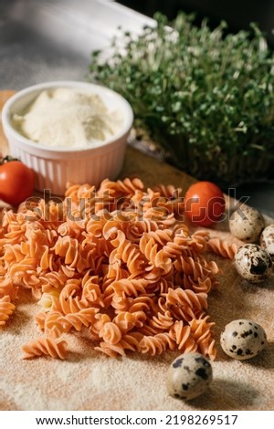 Background texture of tricolor fusilli pasta for traditional Italian and Mediterranean cuisine in a close up full frame view