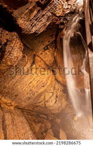 Flowing waterfall underground in Niagara Cave, MN Royalty-Free Stock Photo #2198286675