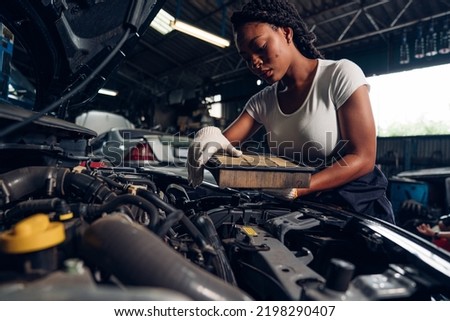 Woman Auto mechanic are repair and maintenance auto engine is problems at car repair shop.	