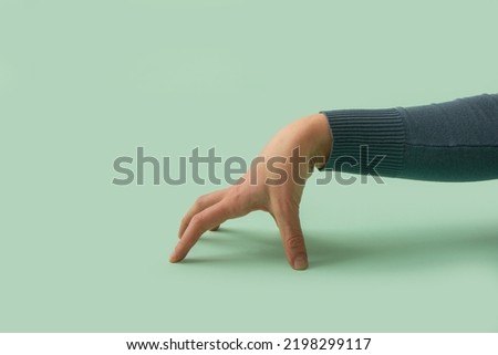 Career hand on a mint green background. Minimal concept for corporate, deal, employment agreement, executive. Decision maker.