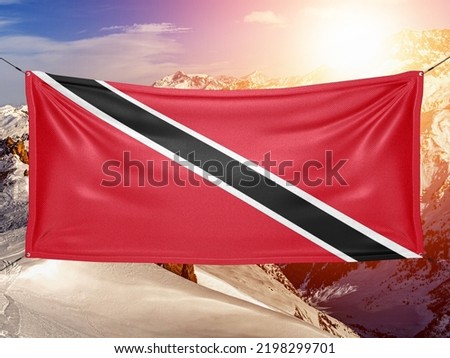 Trinidad and Tobago national flag cloth fabric waving on beautiful background.
