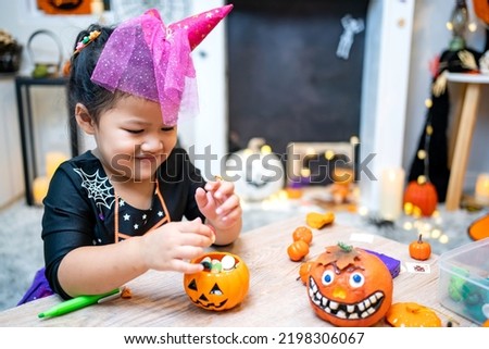 Kid costume for Halloween festival at home. Family celebration and decorated room in Autumn.