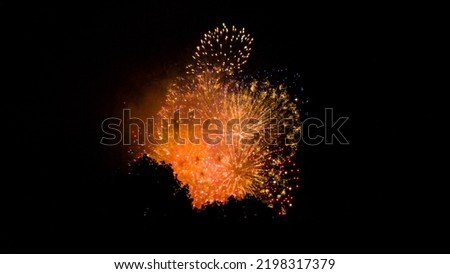 Celebration of holiday, new year, and christmas. Firework or Hanabi being lit at Jingu Gaien Firework Festival during the summer in Tokyo against night sky