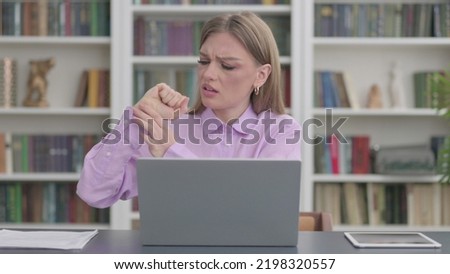 Woman having Wrist Pain while using Laptop in Office