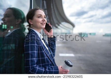 Well dressed young businesswoman with her Smart Phone