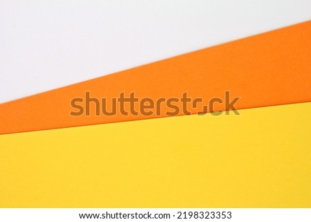 Abstract creative texture geometric candy corn pattern craft paper background. White, orange, yellow colors. Halloween autumn holiday concept. Top view with copy space for text, flat lay, close-up