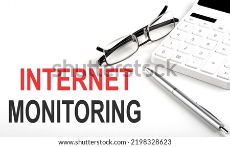 INTERNET MONITORING Concept. Calculator,pen and glasses on a white background