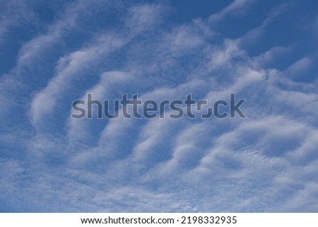 Cirrostratus Clouds look like waves in the sea. Royalty-Free Stock Photo #2198332935