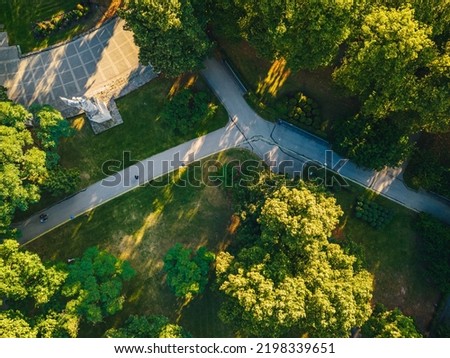 City park from above, summer evening at city park, Pedestrian paths and crosswalks in city park. Green area in the city Royalty-Free Stock Photo #2198339651