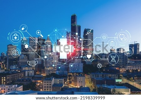 Illuminated aerial cityscape of Seattle, downtown at night time, Washington, USA. Health care digital medicine hologram. The concept of treatment and disease prevention