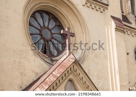 Close-up of a wooden religious Christian cross on the roof of the church.