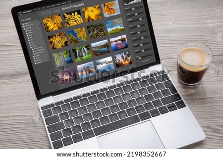 Digital photo files library on laptop computer Royalty-Free Stock Photo #2198352667