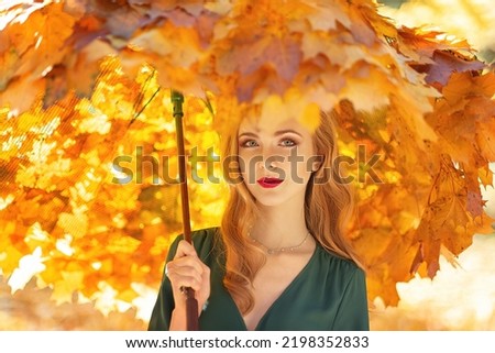 Girl with an umbrella made of maple leaves in the autumn park. Autumn season, art picture