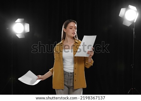 Professional actress reading her script during rehearsal in theatre Royalty-Free Stock Photo #2198367137