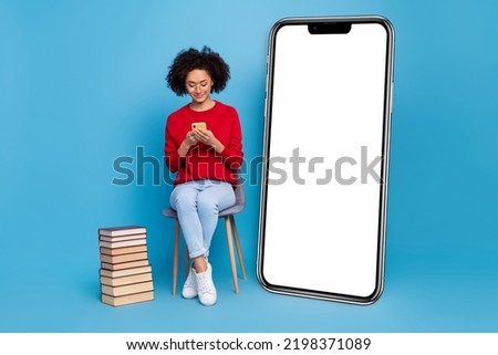 Photo of pretty young woman wear red sweater spectacles chatting gadget empty space isolated blue color background