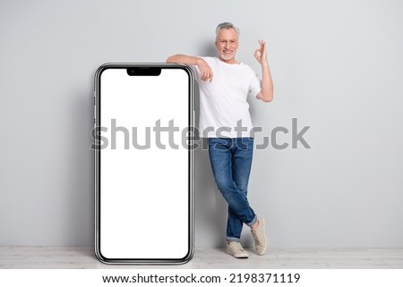 Full length body size view of handsome cheery man showing ok sign copy space solution isolated over concrete grey color wall background
