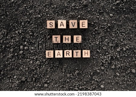 Letter block toy cube wood text Save the Earth word block wooden cubes concept world environment day. Black soil background earth day. Soil earth texture ground soil texture wooden block concept word