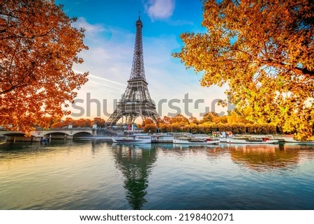 Paris Eiffel Tower and river Seine with sunrise in Paris, France at fall day. Eiffel Tower is one of the most iconic landmarks of Paris.