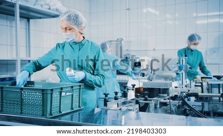 Women work on the capsule packaging line and put the finished product into a box. Bottles on a conveyor belt. Production line of pharmaceutical manufacturing. Pharmaceutical Industry