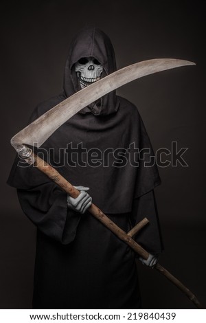 Grim reaper. Death symbols. Halloween. Studio portrait on black background