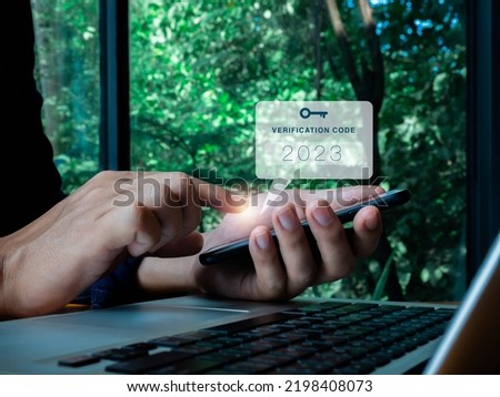 Two steps authentication or 2FA concept. 2023 Verification code with key icon on smart phone screen in hand with laptop for validate password page, Identity verification, cyber security technology. Royalty-Free Stock Photo #2198408073