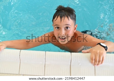 happy boy swimming in the pool