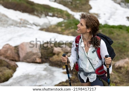 Beautiful Caucasian Curly hair Woman Hiker Waist Up Portrait in Mountain Environment