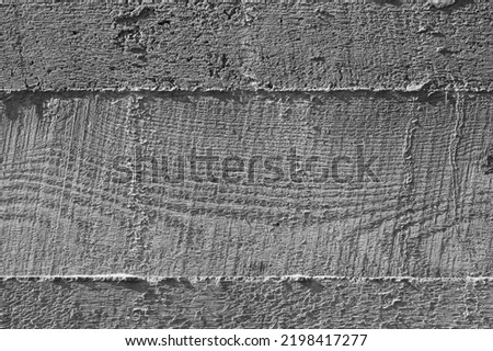 Rough gray concrete wall with imprint relief of wooden formwork, background photo texture