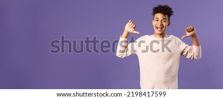 Portrait of confident young upbeat man, smiling bragging, being boastful about own accomplishments, indicate himself with proud rejoicing face, standing purple background Royalty-Free Stock Photo #2198417599
