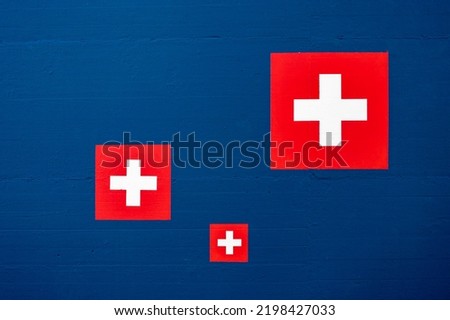 Swiss flag icon on blue wall. Abstract backgrounds.