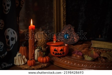 Halloween composition pumpkin orange candles, mystical design for home, interesting ideas for party, details of decor