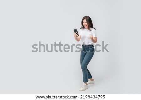 Full length of cheerful Asian woman smiling with using smartphone trading or promotion shopping online on isolated white background. Successful young female trading in smartphone. Creative collage.