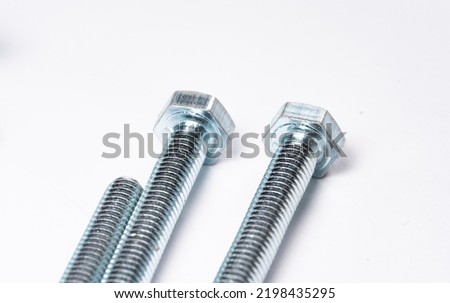 Screws in close-up. Metal long threaded bolts. Metal items. Metal production concept.