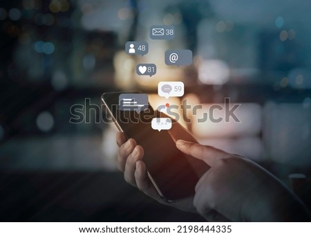 Person hand using a mobile phone with social media marketing concept. Royalty-Free Stock Photo #2198444335
