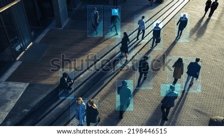 Elevated Security Camera Surveillance Footage of a Crowd of People Walking on Busy Urban City Streets. CCTV AI Facial Recognition Big Data Analysis Interface Scanning, Showing Personal Information. Royalty-Free Stock Photo #2198446515