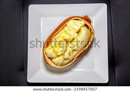 Ripe cupuaçu fruit (Theobroma grandiflorum) opened showing the seeds and the husk of the fruit. Top view Royalty-Free Stock Photo #2198457007