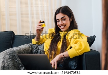 Enthusiastic young girl woman, ordering a delivery with her new credit card, from bed.