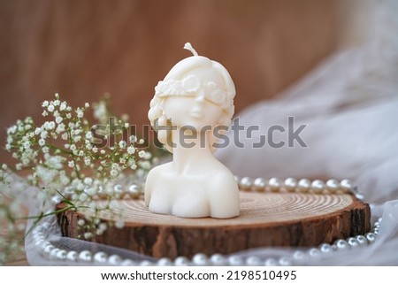 Decorative candle in form of woman bust. Soy candle handmade. Concept of femininity Royalty-Free Stock Photo #2198510495