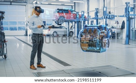 Premium Car Service Manager Uses a Futuristic Virtual Reality Headset Diagnostics Gadget with Controllers. Specialist Inspecting the V6 Internal Combustion Engine for Parts and Component Numbers.