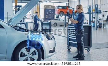 Female Mechanic Uses a Tablet Computer with an Augmented Reality Diagnostics Software. Specialist Inspecting Car's V6 Engine in Order to Find Broken Components. Hi-tech Modern Car Service.