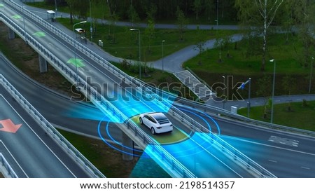 Following Aerial Drone View: Autonomous Self Driving Car Moving Through Megapolis City Highway. Visualization Concept: Sensor Scanning Road Ahead for Vehicles, Speed Limits. Day, Driveway.
